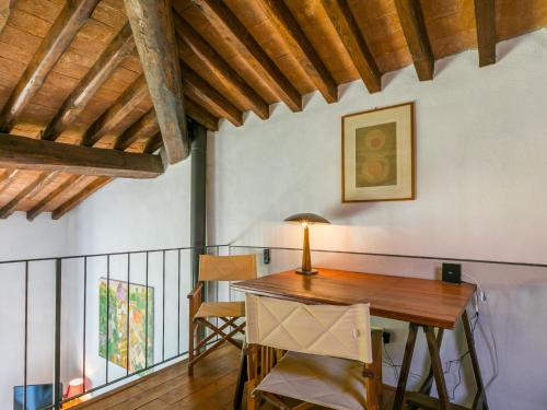 a dining room with a wooden table and chairs at Holiday Home Marte by Interhome in Pereta