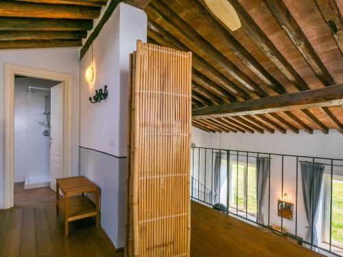 an open door in a room with a wooden ceiling at Holiday Home Marte by Interhome in Pereta