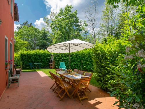 a patio with a table and an umbrella at Apartment Matteo by Interhome in Avaglio
