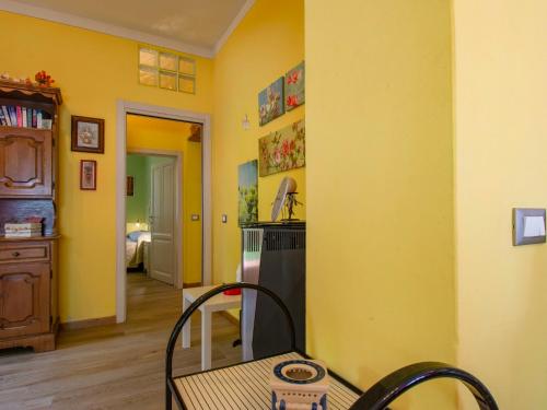 a kitchen with yellow walls and a table and chairs at Apartment Matteo by Interhome in Avaglio