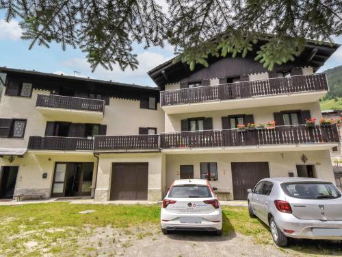 two cars parked in front of a building at Apartment Isola di Madesimo Apartments-1 by Interhome in Isola