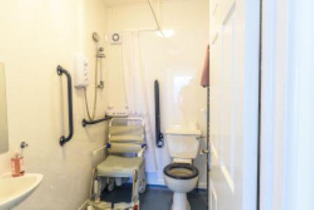 a bathroom with a toilet and a sink at Lanehouse Rocks in Weymouth