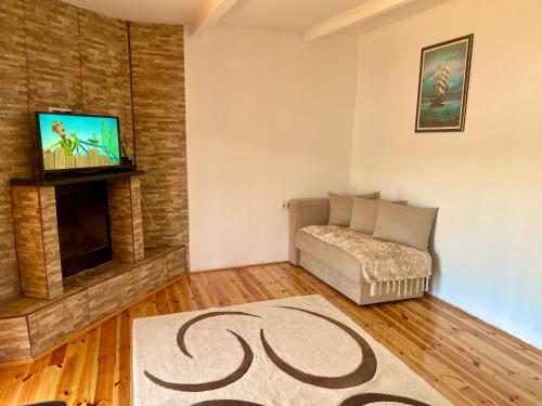 a living room with a couch and a flat screen tv at Apartment Soreja in Ulcinj
