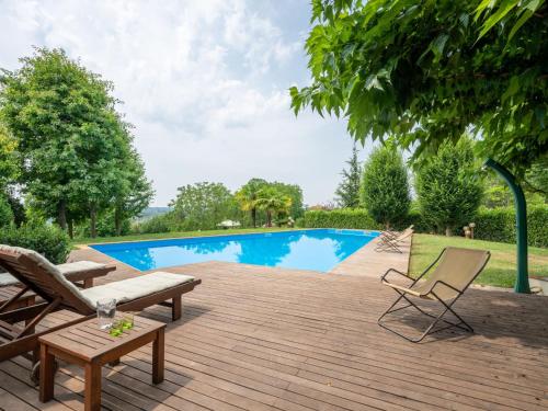 una terraza de madera con sillas y una piscina en Apartment da Nonna Ina by Interhome, en Prazzo