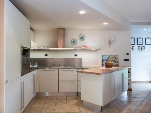 a kitchen with white cabinets and a counter top at Apartment da Nonna Ina by Interhome in Prazzo