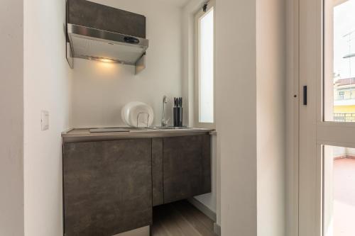 a kitchen with a sink and a microwave at Residence Velò - Bike & Family in Giulianova