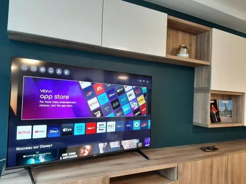 a large flat screen tv sitting on top of a shelf at Au Grand Pierrot in Spa