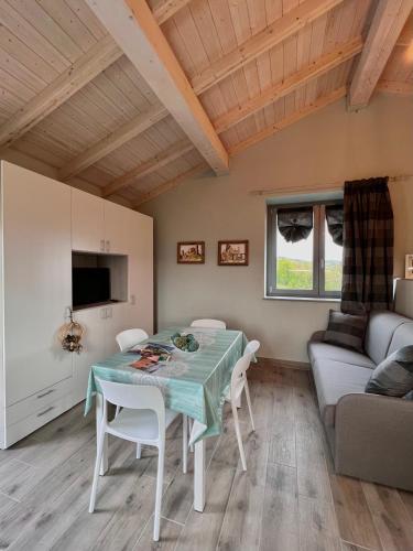 a living room with a table and a couch at Il Paradiso di Pietra in Filetto