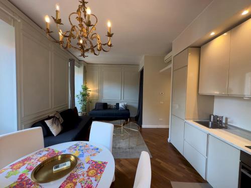 a kitchen and a living room with a table and chairs at Appartme Stampa 1 in Milan
