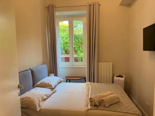 a small bedroom with a bed and a window at Appartme Stampa 1 in Milan