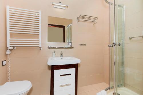 a bathroom with a sink and a shower at Villa Baltic Dream in Międzyzdroje
