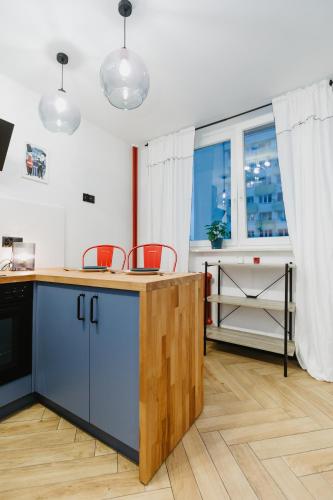 a kitchen with a counter and a large window at Apartament Lwowska in Lublin