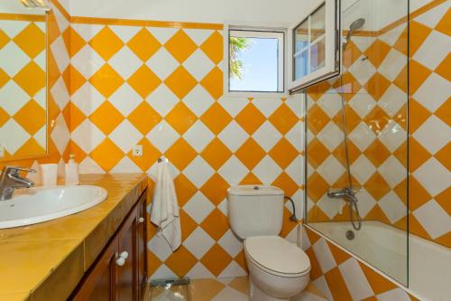 a bathroom with a toilet and a sink at Aloes in Sa Caleta