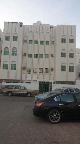 a black car parked in front of a large building at Madinah Anbariah in Al Madinah