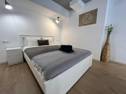 a white bedroom with a large bed in a room at Carbonell 1 in Valencia