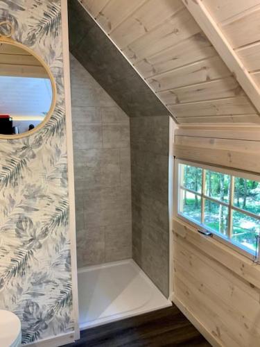 a small bathroom with a shower and a window at La Cabane perchée de la Mure in Bongheat