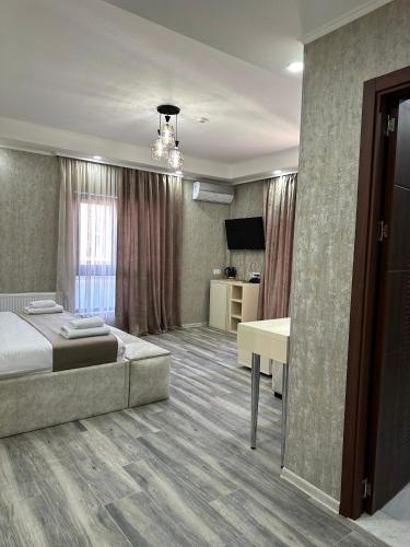a hotel room with a bed and a desk at Luxmani Hotel & Spa in Tbilisi City
