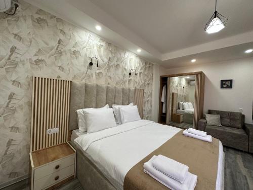 a bedroom with a large bed and a couch at Luxmani Hotel & Spa in Tbilisi City