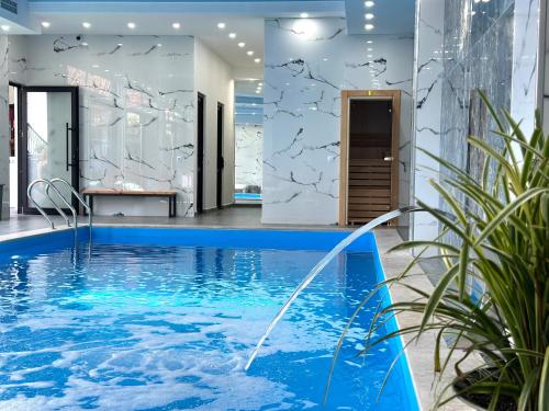 a pool with a water fountain in the middle of a building at Luxmani Hotel & Spa in Tbilisi City