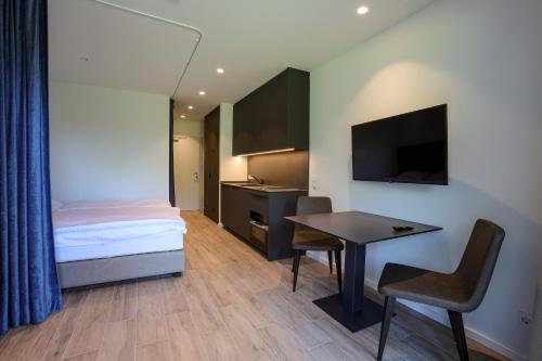 a bedroom with a bed and a desk and a table at Casa Grande in Techelsberg am Worthersee