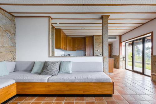 a living room with a large couch in a kitchen at Casa Letrigo in Arcos de Valdevez