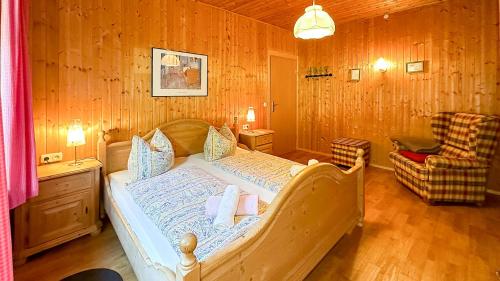 a bedroom with a bed in a room with wooden walls at Almbauernhof in Ruhpolding