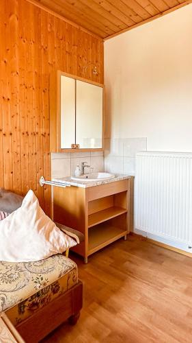 a bathroom with a sink and a mirror at Almbauernhof in Ruhpolding