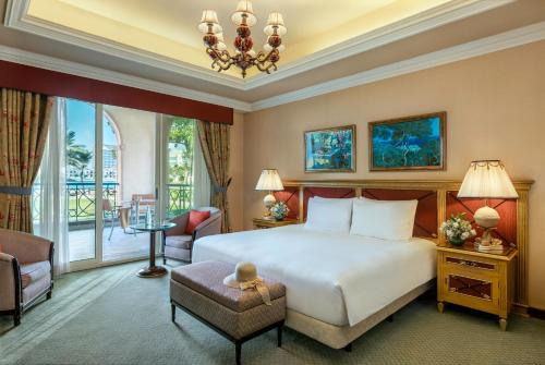 a hotel room with a bed and a balcony at Al Raha Beach Resort & Spa in Abu Dhabi