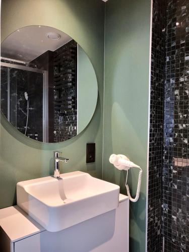 a bathroom with a white sink and a mirror at Apartament Bel Mare F 604 in Międzyzdroje