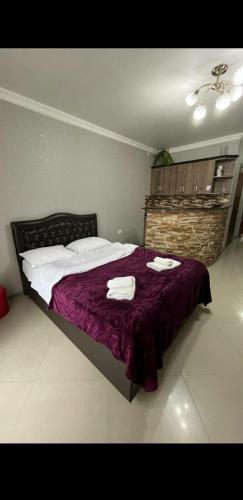 a bedroom with a bed with two towels on it at Orbi Sea Towers in Batumi