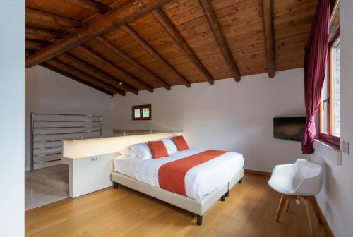 a bedroom with a bed and a desk and a television at Parco San Marco Lifestyle Beach Resort in Porlezza