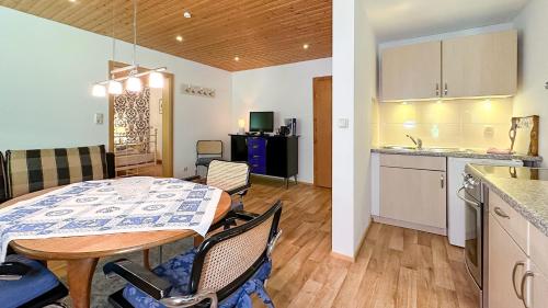 a kitchen and a dining room with a table and chairs at Almbauernhof in Ruhpolding