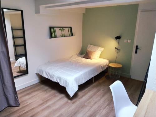 a bedroom with a white bed and a mirror at Zenitude Place in Margny-lès-Compiègne