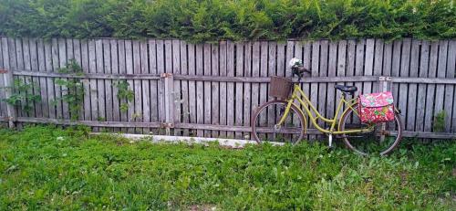 a yellow bike parked next to a fence at Hygge home w free parking in Tartu