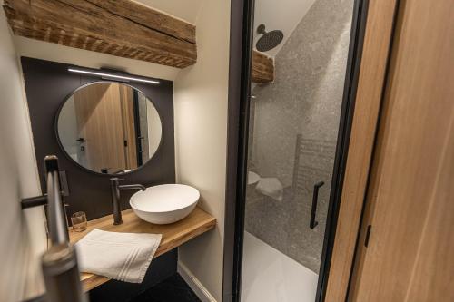 a bathroom with a sink and a mirror at La Tannerie de Durbuy Guesthouse in Durbuy