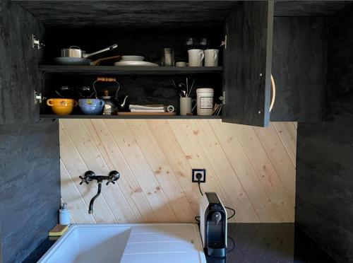 a kitchen with a sink and aaucet at Obytný kontejner Cabin Stars in Zátor