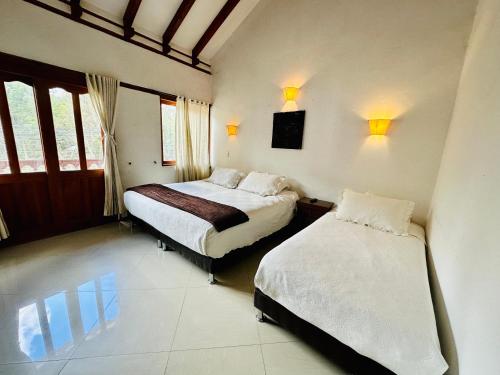 Katil atau katil-katil dalam bilik di Hotel Oasis de la villa