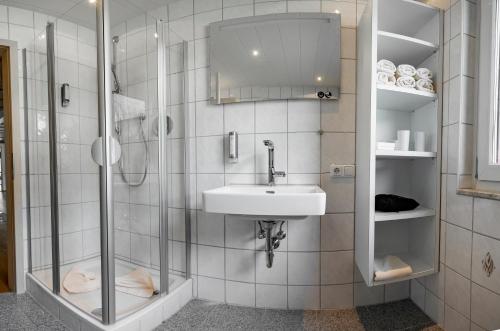 a bathroom with a sink and a shower at Hubertus Gartenlodge in Mittelberg