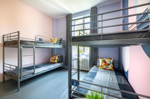 two bunk beds in a room with purple walls at Bla Bla Hostel in Sofia