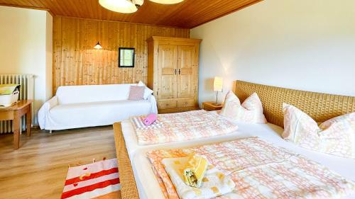 a hotel room with two beds and a table at Almbauernhof in Ruhpolding