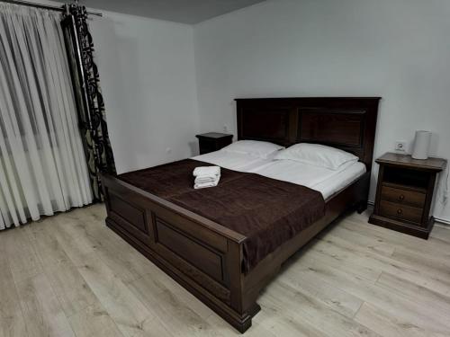 a bedroom with a large bed and two night stands at Craita in Căpăţîneni-Ungureni