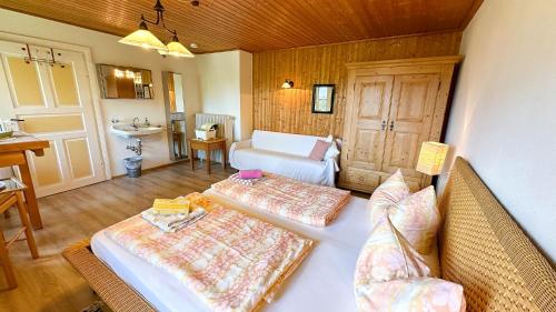 a room with two beds and a sink in it at Almbauernhof in Ruhpolding