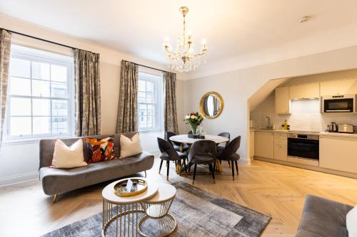 a living room with a couch and a table at RÌGH Properties - Luxurious City Centre Three Bedroom Apartment in Edinburgh