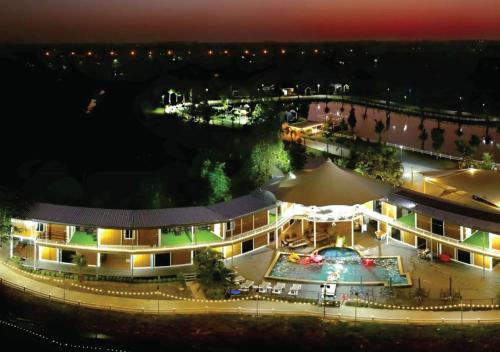 an aerial view of a building with a pool at night at Hi Creek Resort 