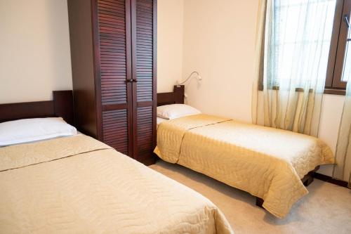 a bedroom with two beds and a window at Villa Chantal in Kotor