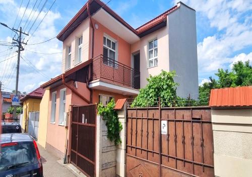 a house with a gate and a fence at Central Park House in Cluj-Napoca