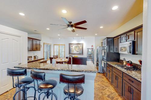 a kitchen with a center island with bar stools at Tranquil Tierra in Palm Springs