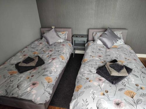 two beds sitting next to each other in a bedroom at Perfect Gites In Normandy in Saint-Sauveur-de-Chaulieu