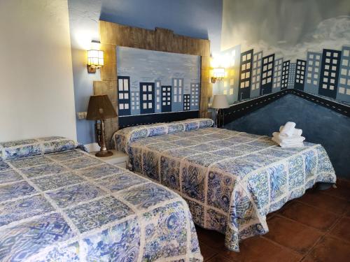 a hotel room with two beds in a room at Posada de Ongayo in Suances