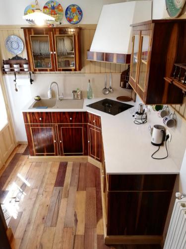 a kitchen with wooden cabinets and a white counter top at Luciano e Concetta in Ragusa